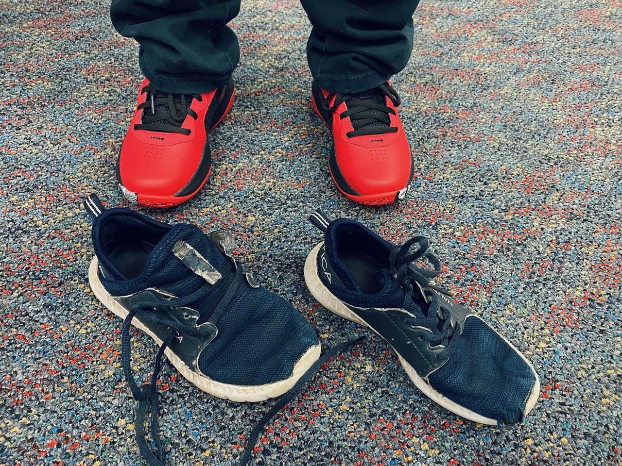 Bright red new sneakers next to the worn-out pair they replaced
