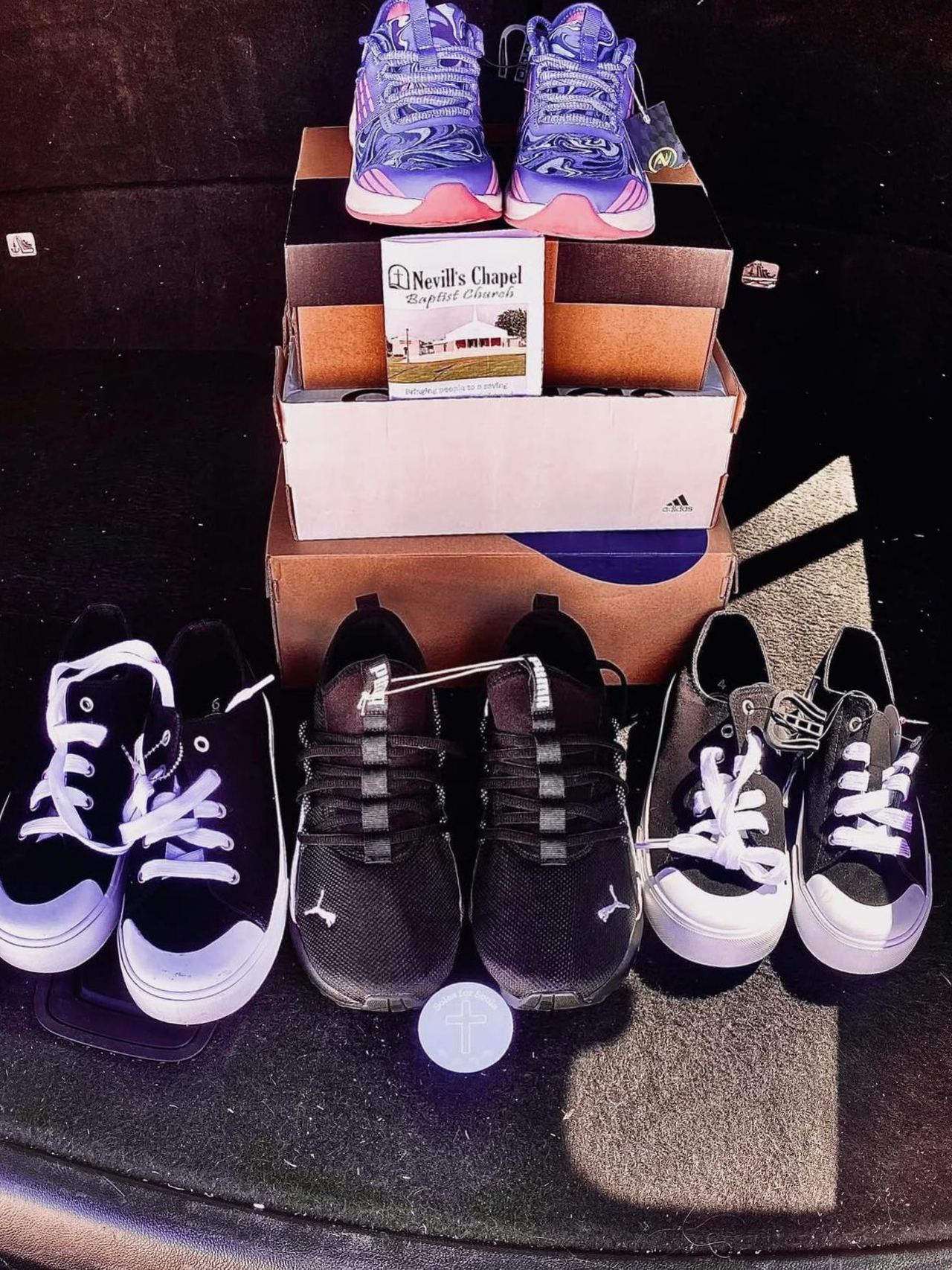 Stacks of new shoes ready for delivery with a Nevill's Chapel gospel booklet