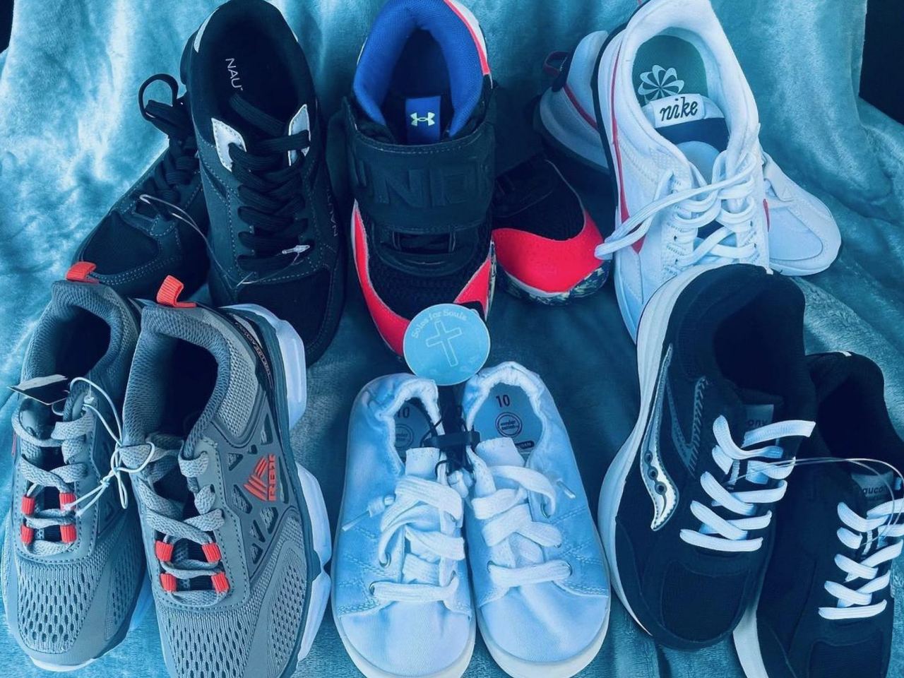 Seven pairs of new shoes ready to be given away